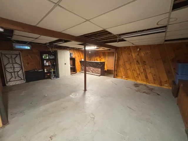 Open floor around the basement bar and refrigerator after cleanout
