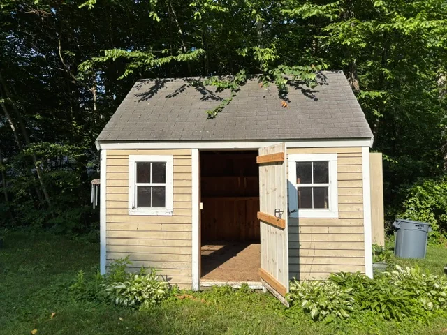 Garden shed with its door open before demolition